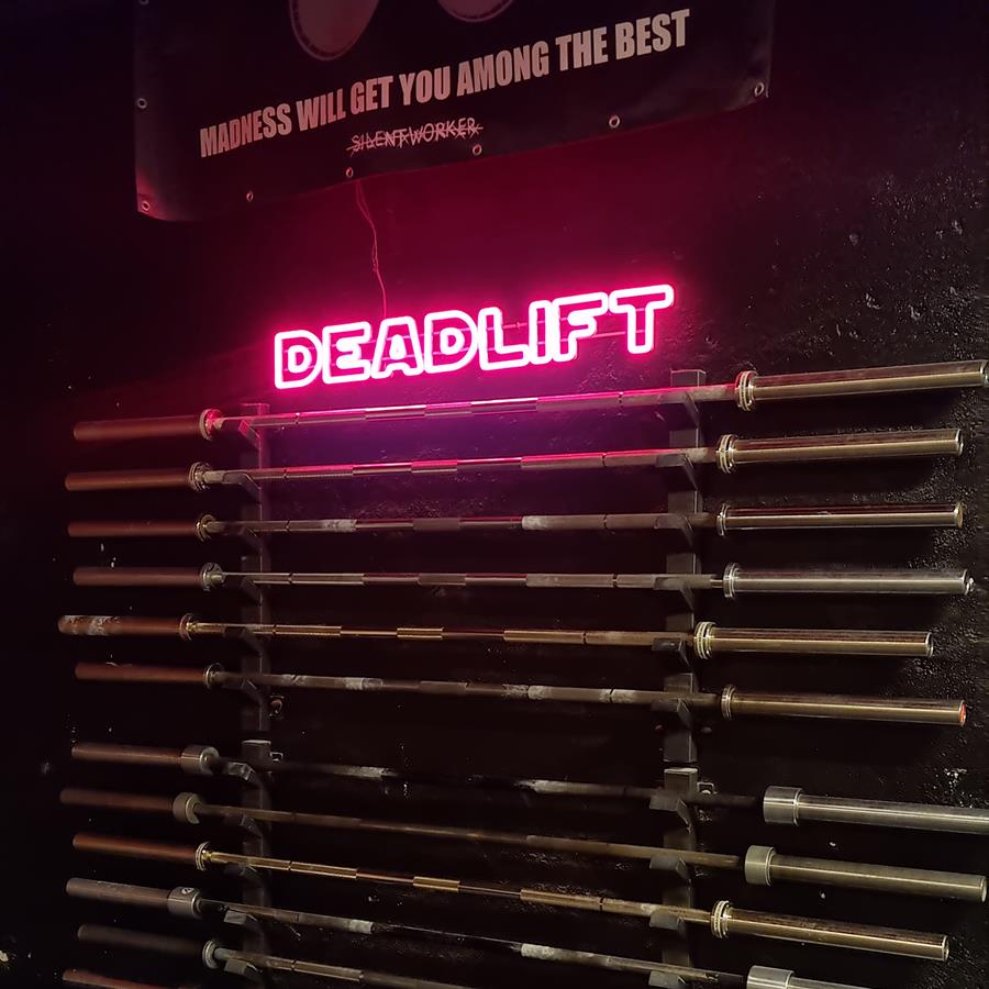 Barbell wall rack and the DEADLIFT neon sign