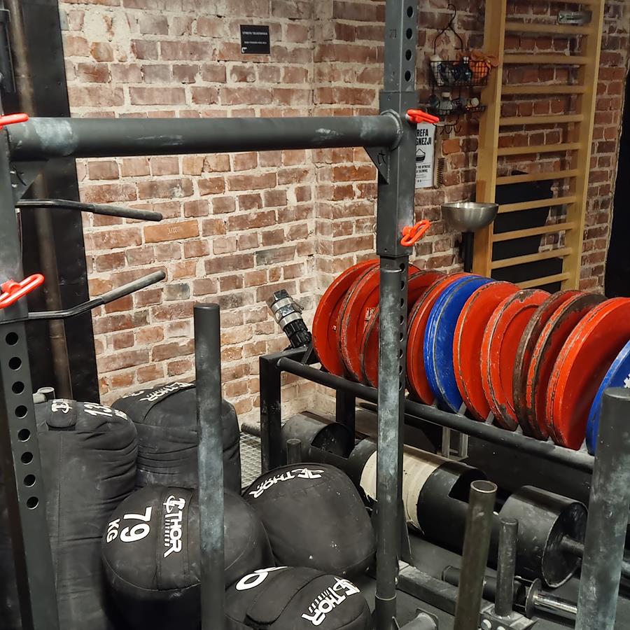 Squat rack, kettlebells and strongman sandbags